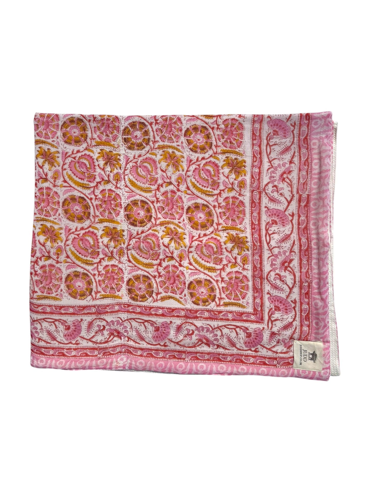 A folded square scarf or shawl featuring a detailed pink, orange, and white block print pattern with floral and paisley motifs, shown against a plain white background.