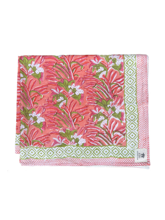 Floral patterned fabric with pink and green colors on a white background