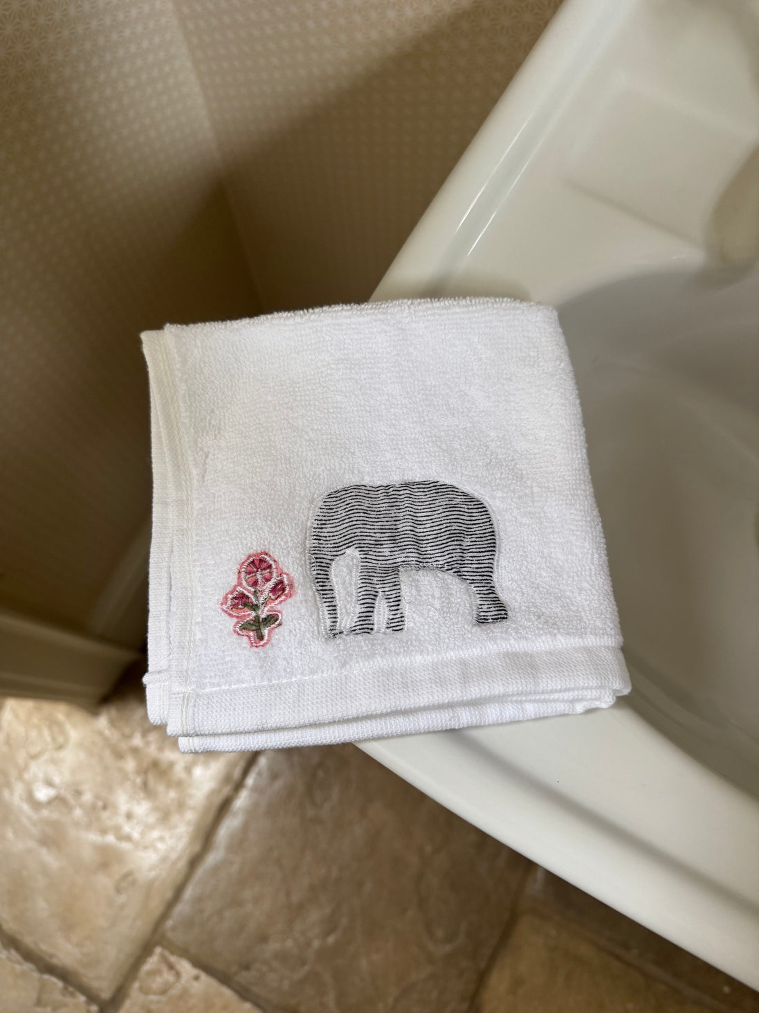 Embroidered face cloth featuring cypress tree & elephant design, 100% cotton
