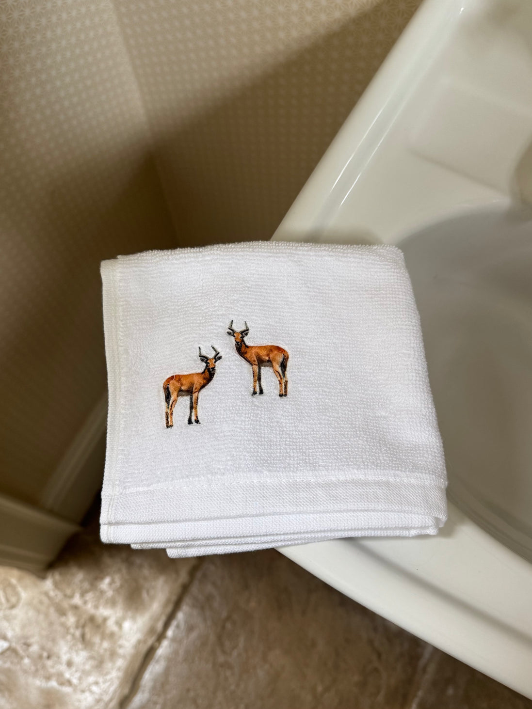 Embroidered face cloth featuring deer design, 100% cotton