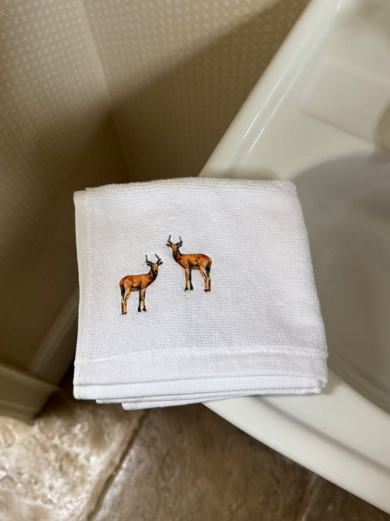Embroidered face cloth featuring deer design, 100% cotton