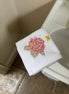 Embroidered face cloth featuring pink hydrangea & butterfly design, 100% cotton