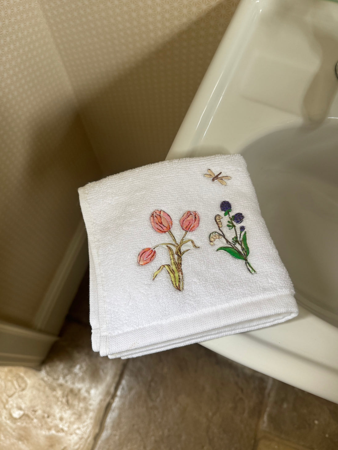 Embroidered face cloth featuring spring garden design, 100% cotton